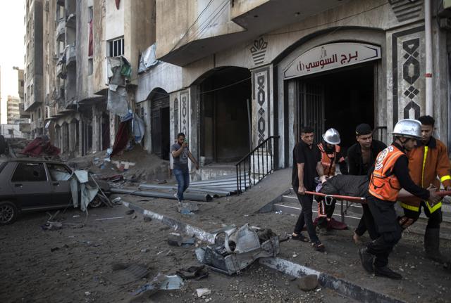 Soccorritori evacuano un'anziana ferita dai razzi israeliani a Gaza Soccorritori evacuano un'anziana ferita dai razzi israeliani a Gaza