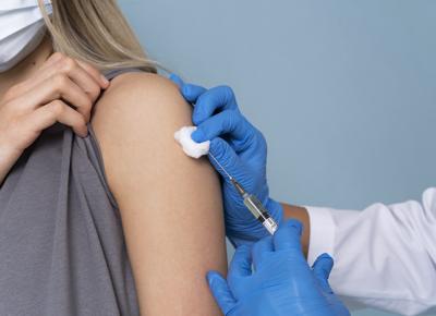female patient with medical mask getting a vaccine