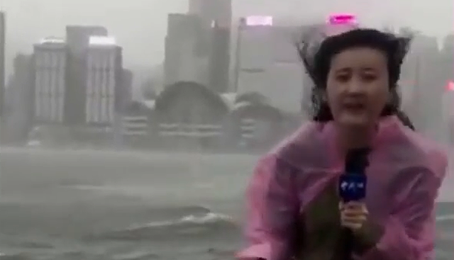 Maltempo a Hong Kong, la giornalista lotta contro le raffiche di vento del tifone che sta colpendo l'Asia