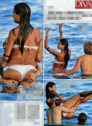 Naike nuda tra le lenzuola con cane e gatto