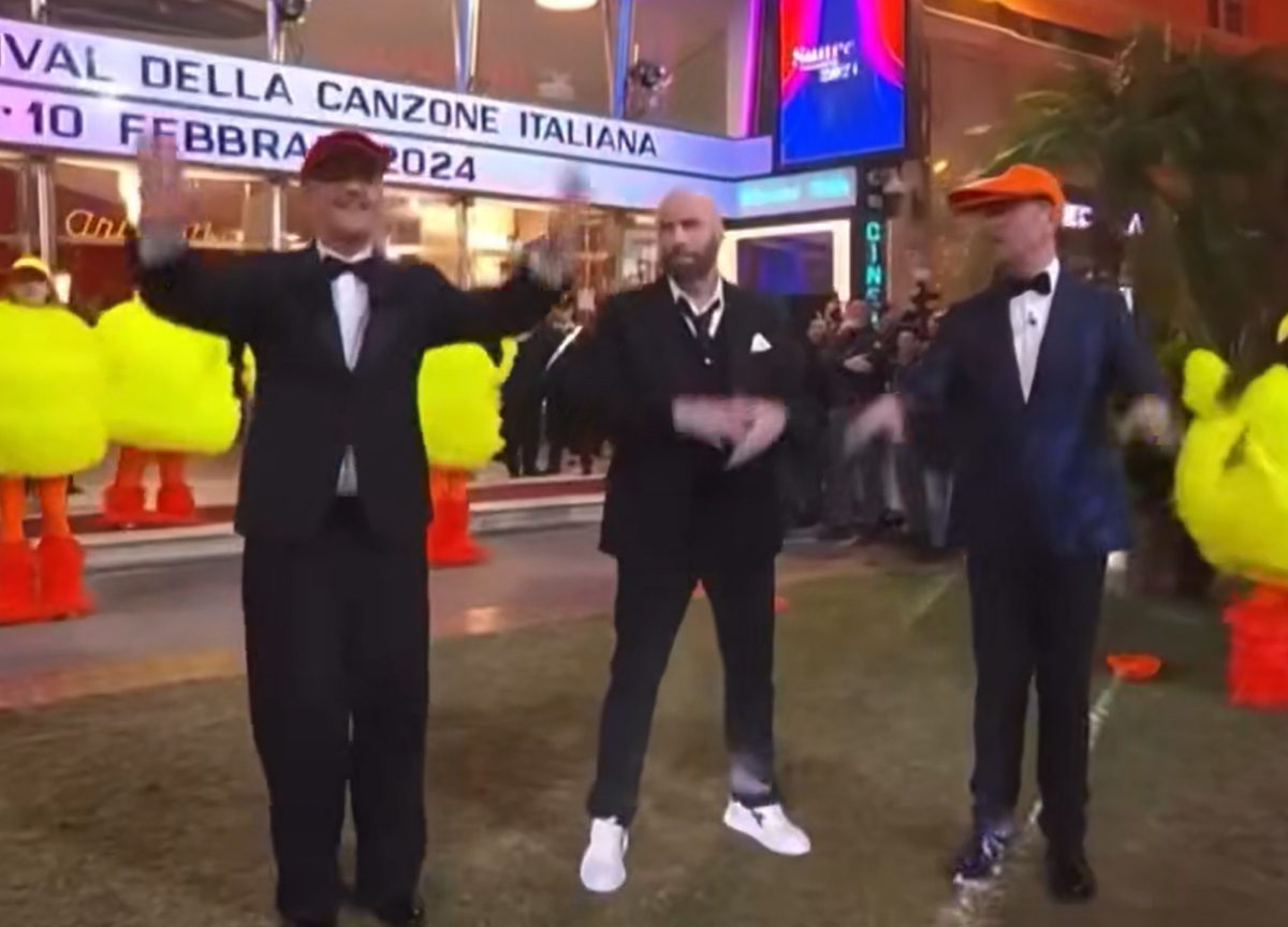 Amadeus smascherato su Travolta. “Don’t worry be happy”, solo un caso?