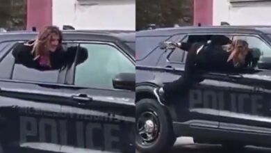 Donna scappa dalla macchina della polizia dal finestrino, la scena da film d’azione
